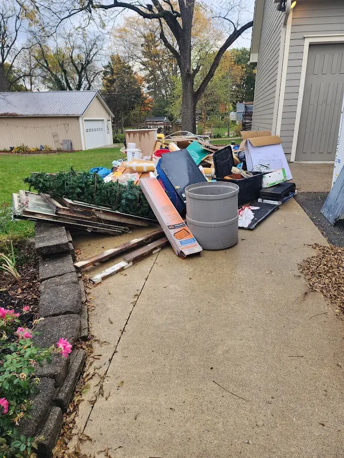 Dumpster being loaded with debris for Roofing Dumpster Rental in Lakeway